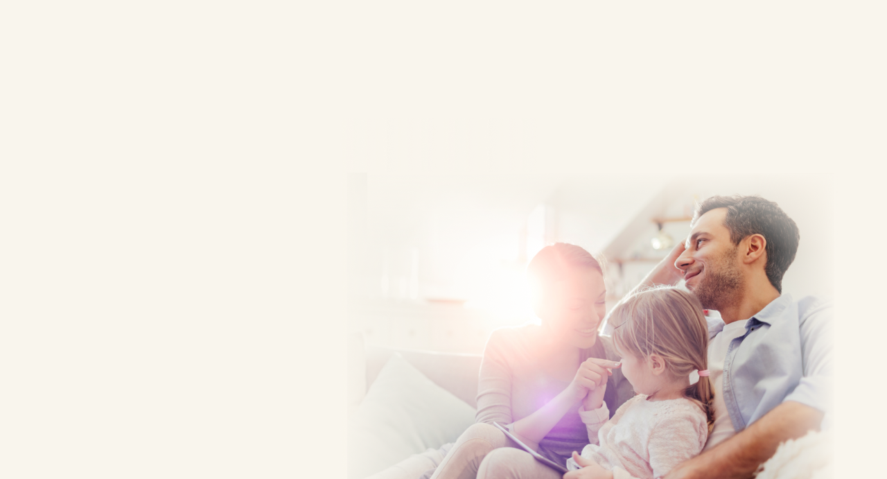 Family on couch with sunshine coming in through window