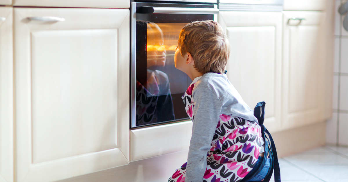 Kid in front of oven