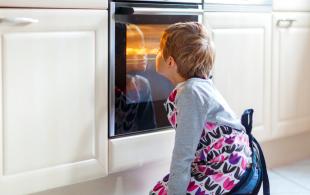 Kid in front of oven